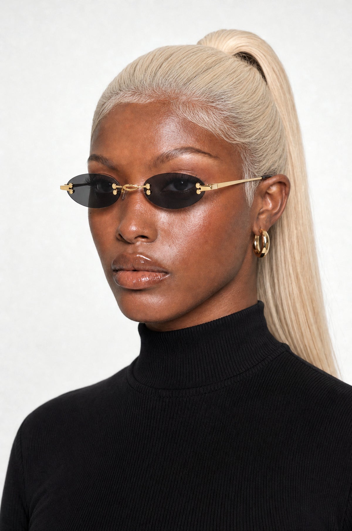 The Chiswick Oval Sunglasses in Gold Black, worn, three-quarter view