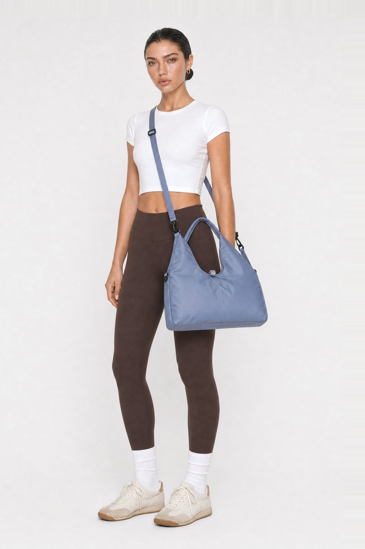 The Greenwich Travel Bag in Misty Blue, worn crossbody