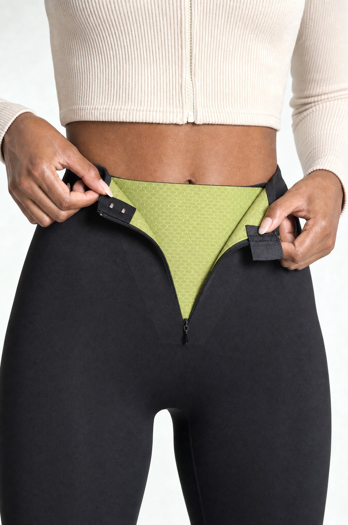 The Regent Tummy-Control Leggings: front zip and hooks opened to show the green shaping layer inside