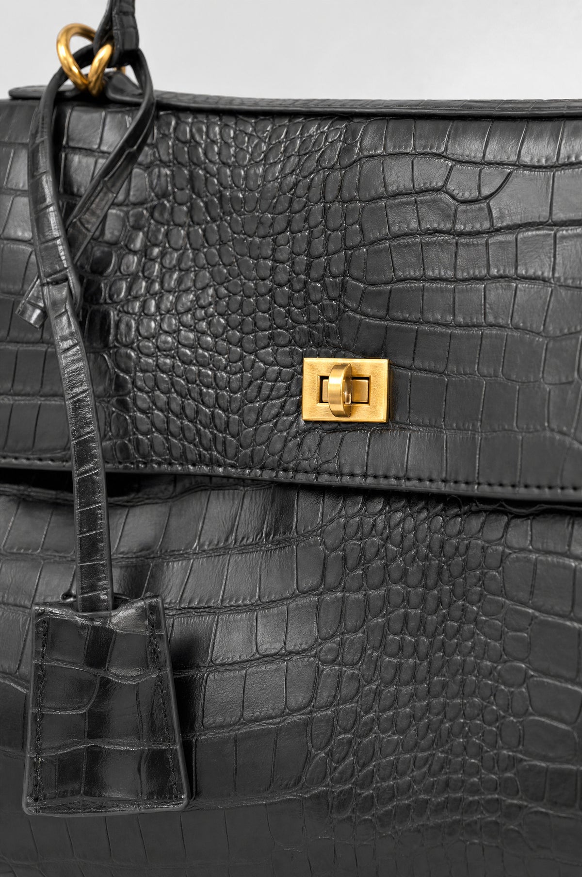The Marylebone Croc-Effect Tote in Black, close-up of the croc grain and twist-lock