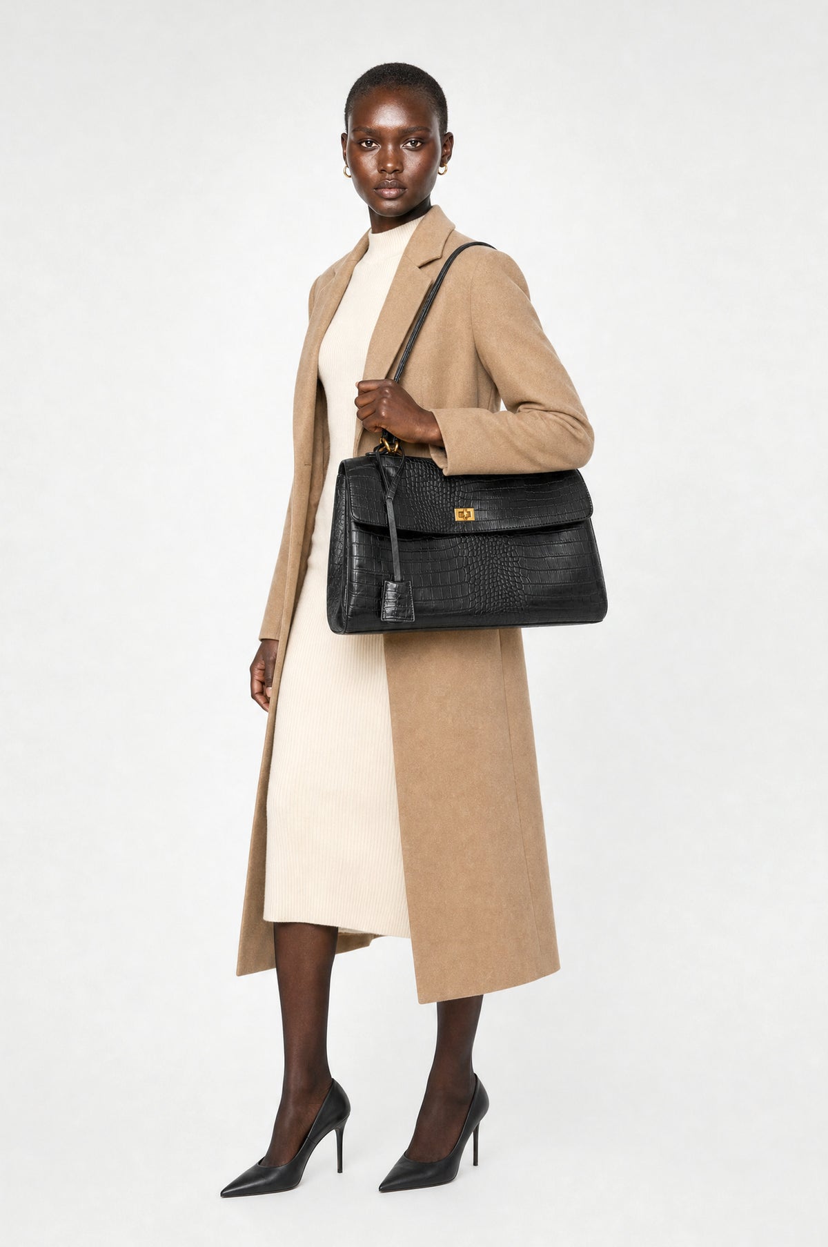 The Marylebone Croc-Effect Tote in Black, worn on the shoulder