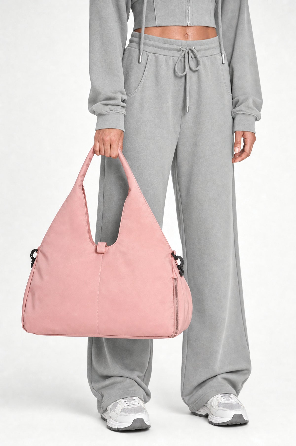 The Greenwich Travel Bag in Pink, detail, held at the hip