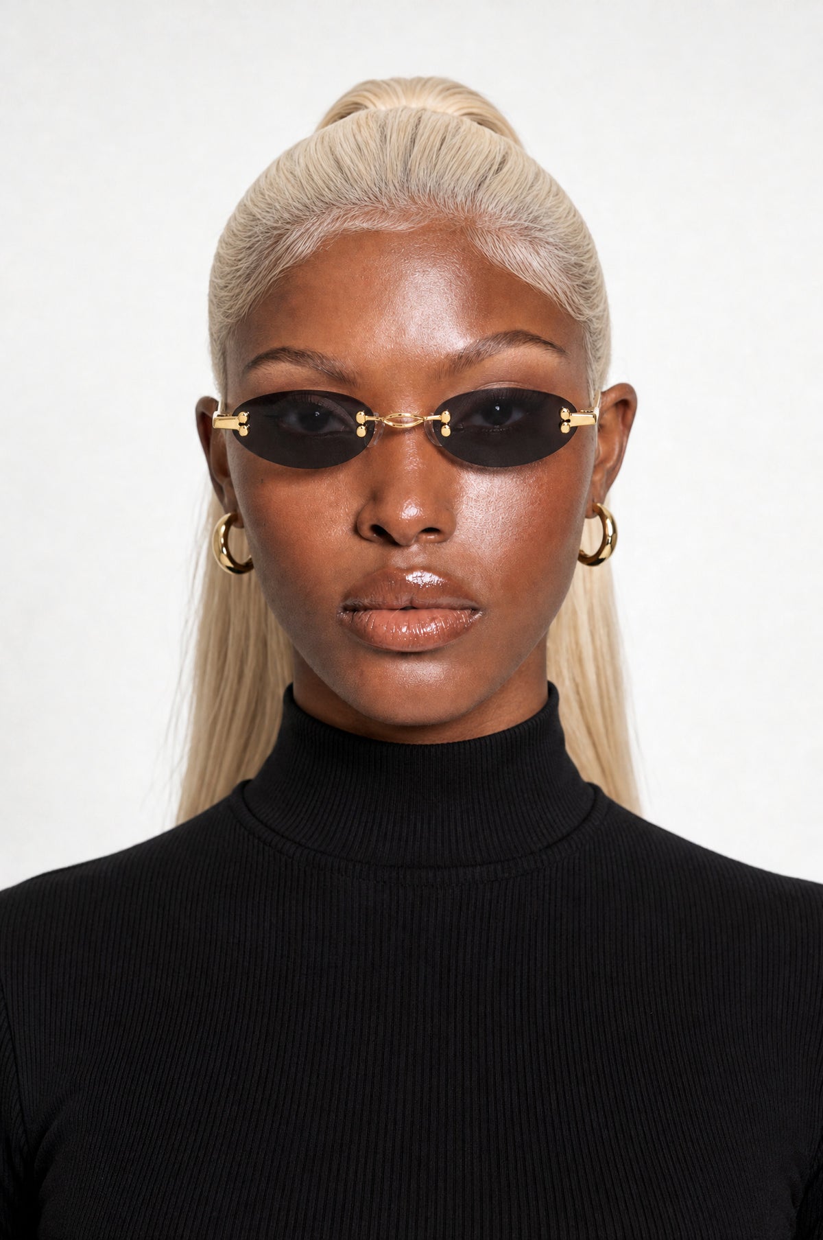 The Chiswick Oval Sunglasses in Gold Black, worn