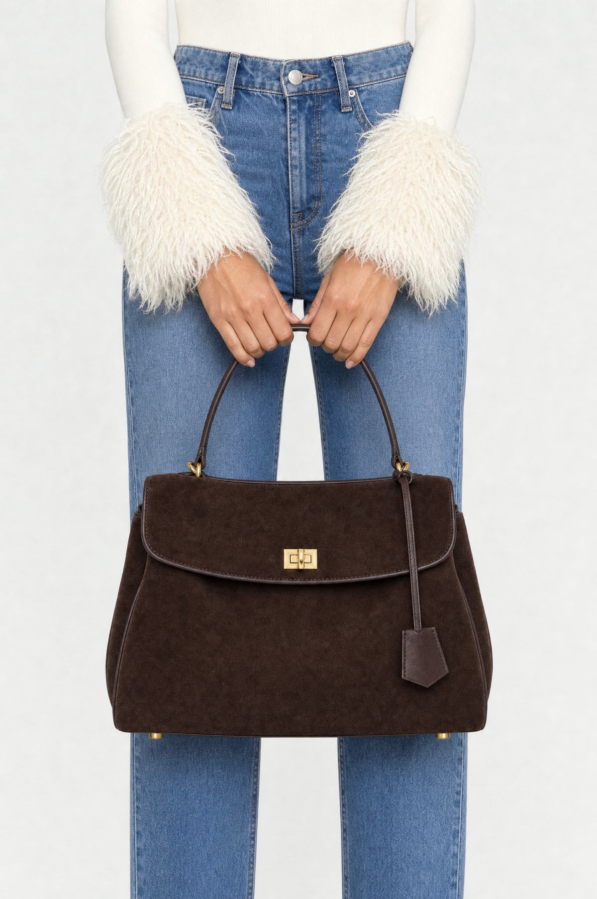 The Kensington Top-Handle Bag in Coffee, close-up held by the top handle, closed