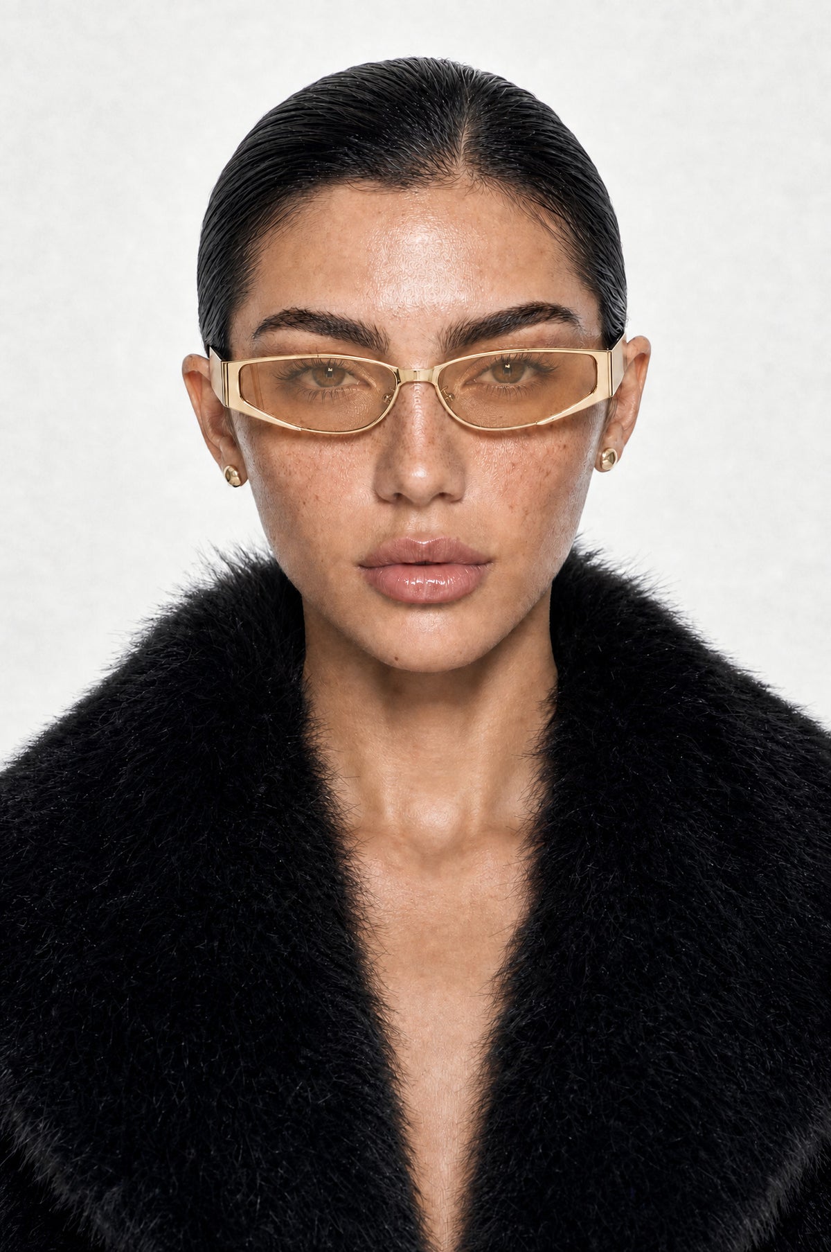The Putney Wrap Sunglasses in Gold Peach, worn, front