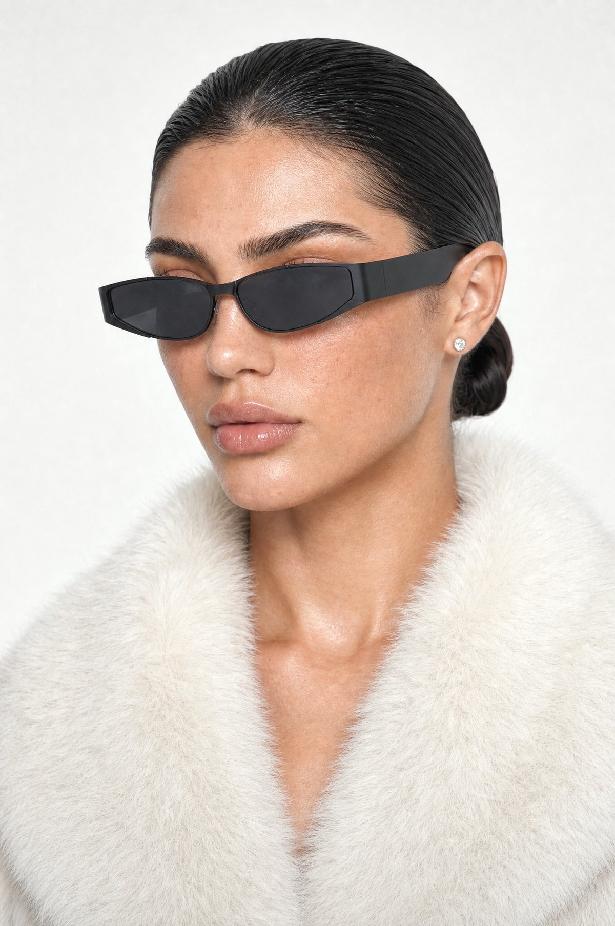 The Putney Wrap Sunglasses in Black, worn, three-quarter