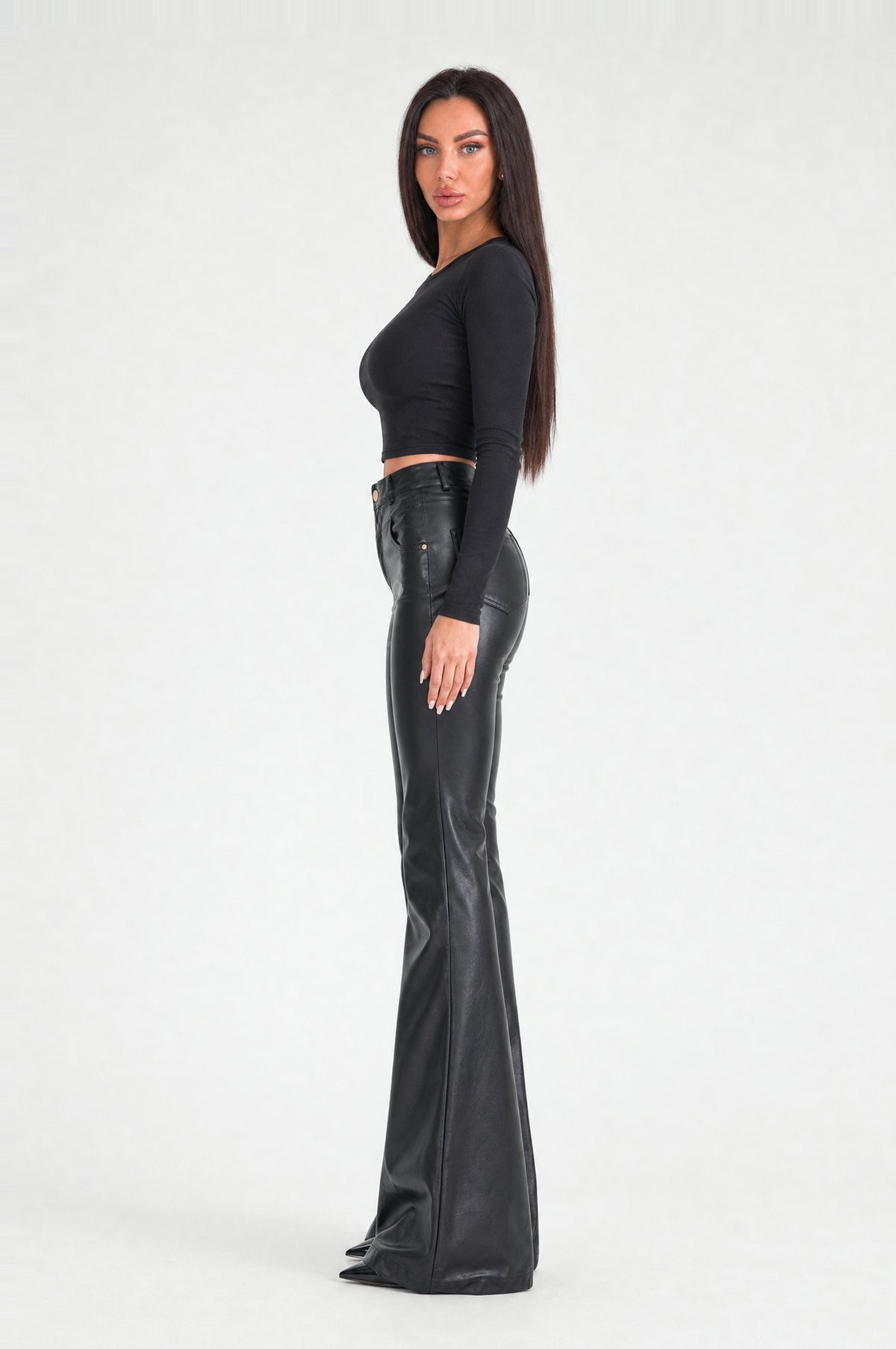 The Fulham Faux Leather Flared Trousers in Black, side, looking at camera