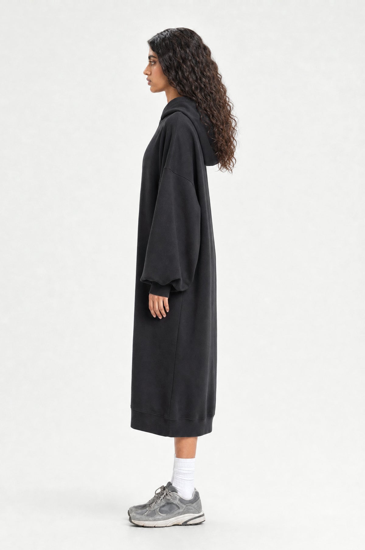 The Camden Hoodie Dress in Black, side profile