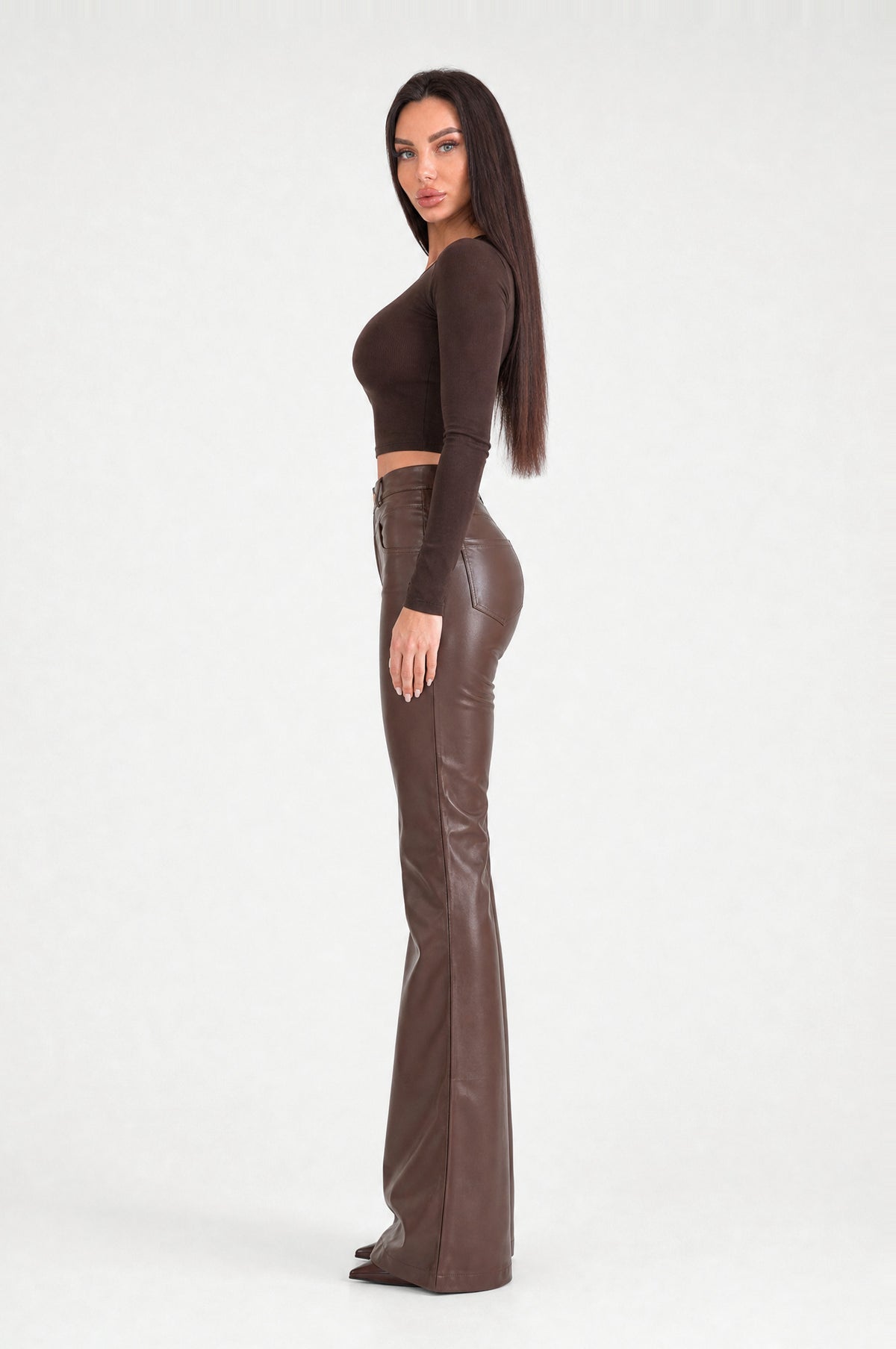 The Fulham Faux Leather Flared Trousers in Coffee, side, looking at camera