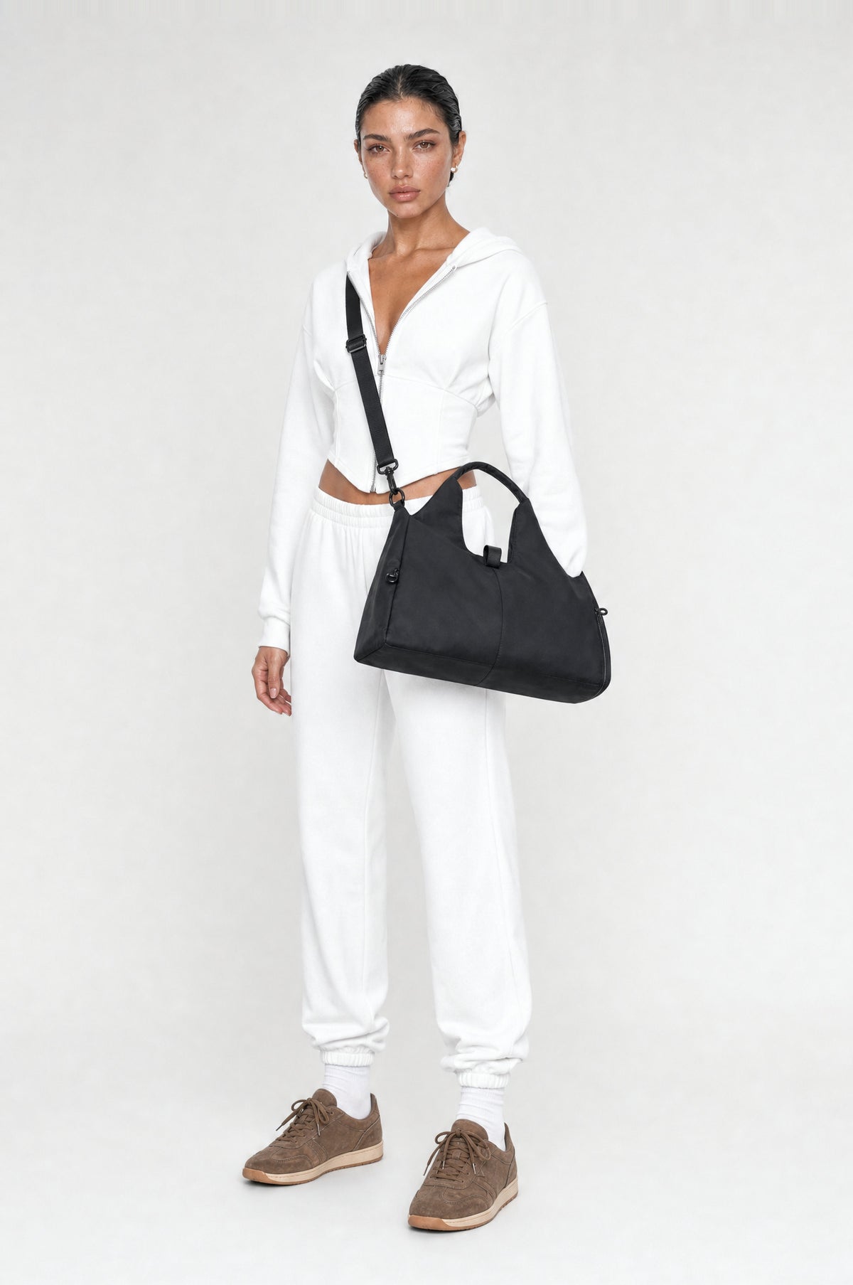 The Greenwich Travel Bag in Black, worn crossbody