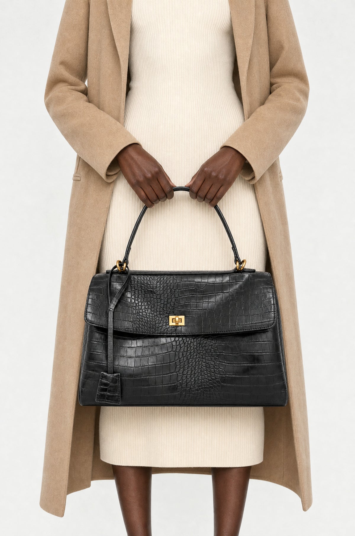 The Marylebone Croc-Effect Tote in Black, close-up held by the top handle, closed (shown in Large)