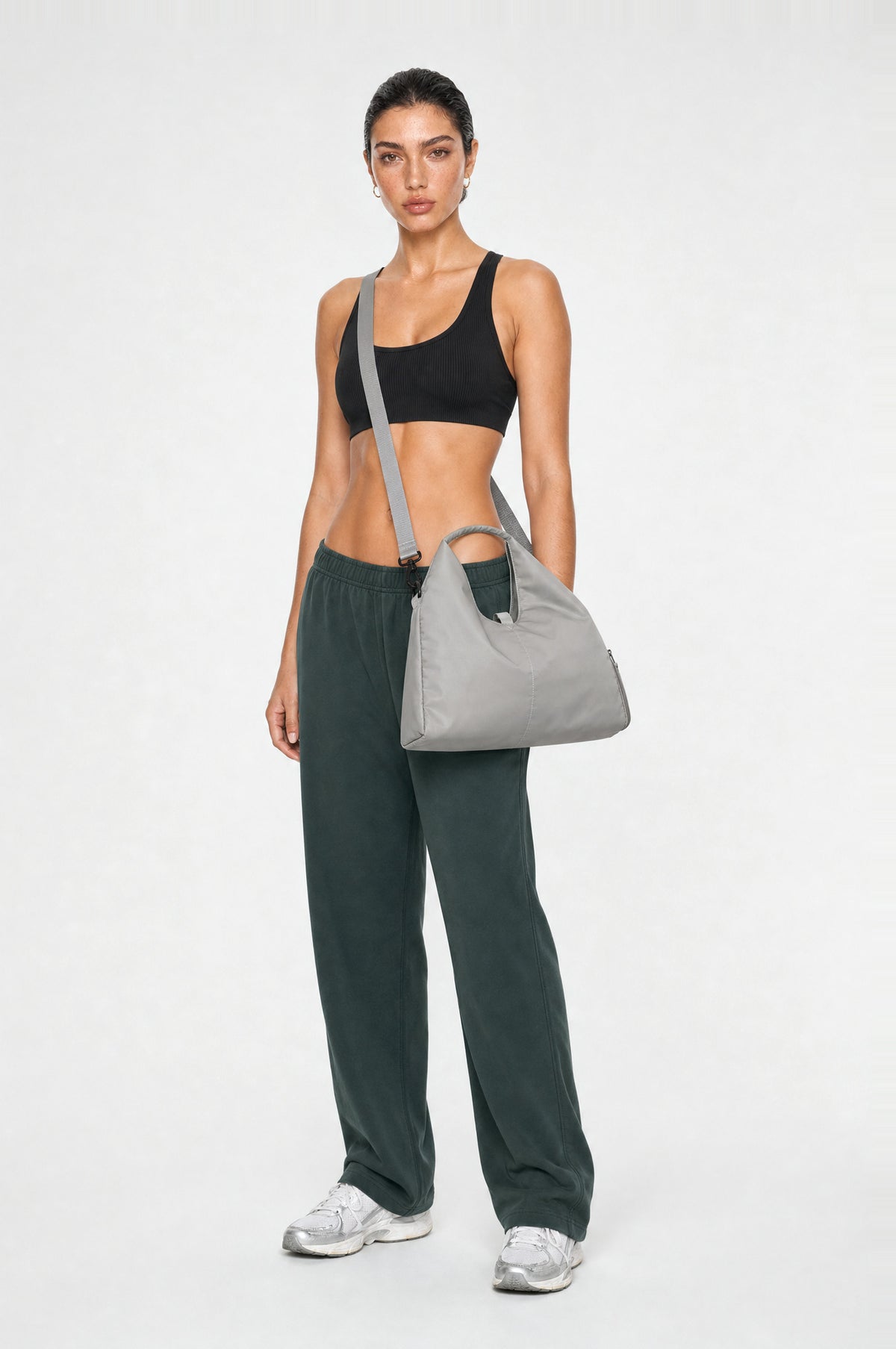 The Greenwich Travel Bag in Grey, worn crossbody