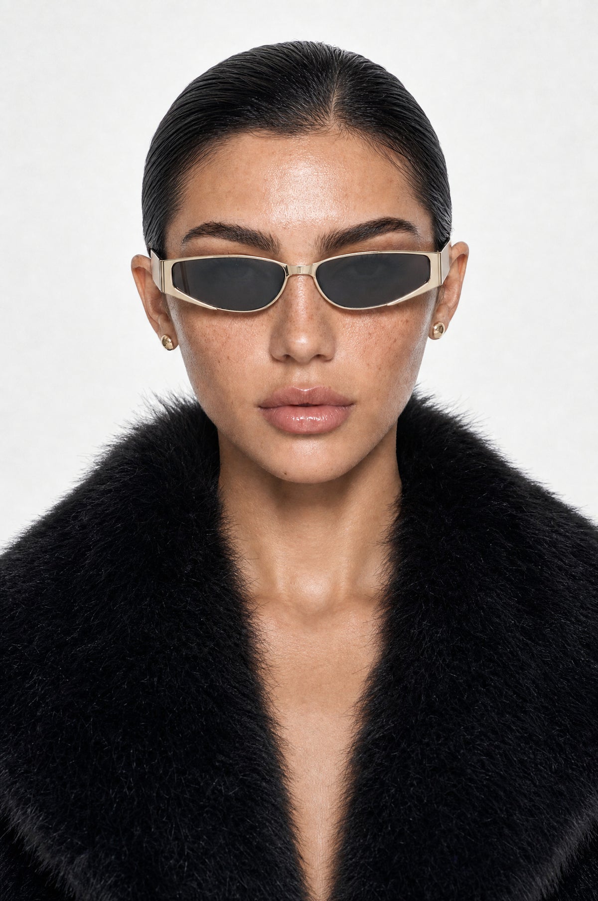 The Putney Wrap Sunglasses in Gold, worn, front
