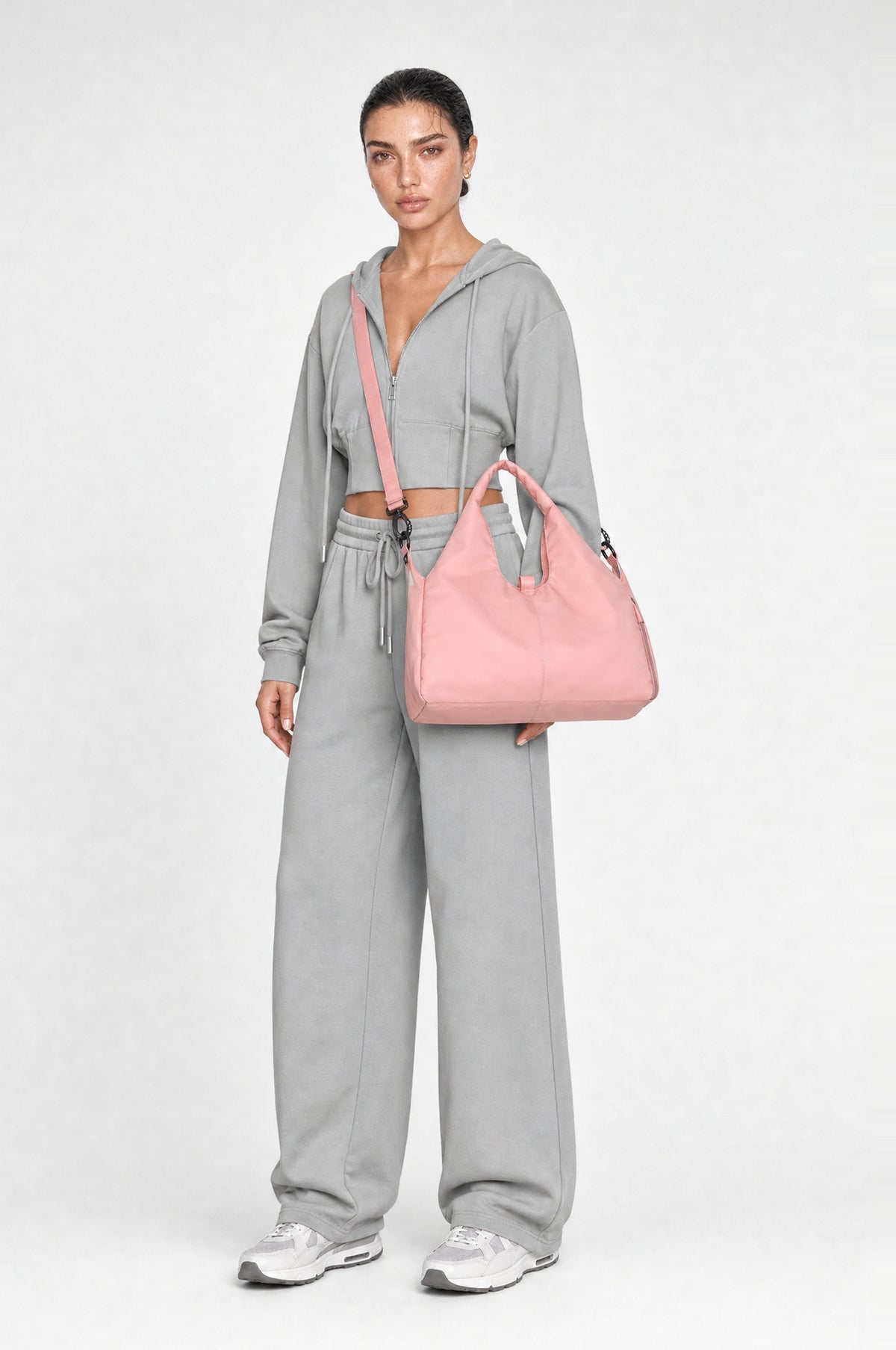 The Greenwich Travel Bag in Pink, worn crossbody