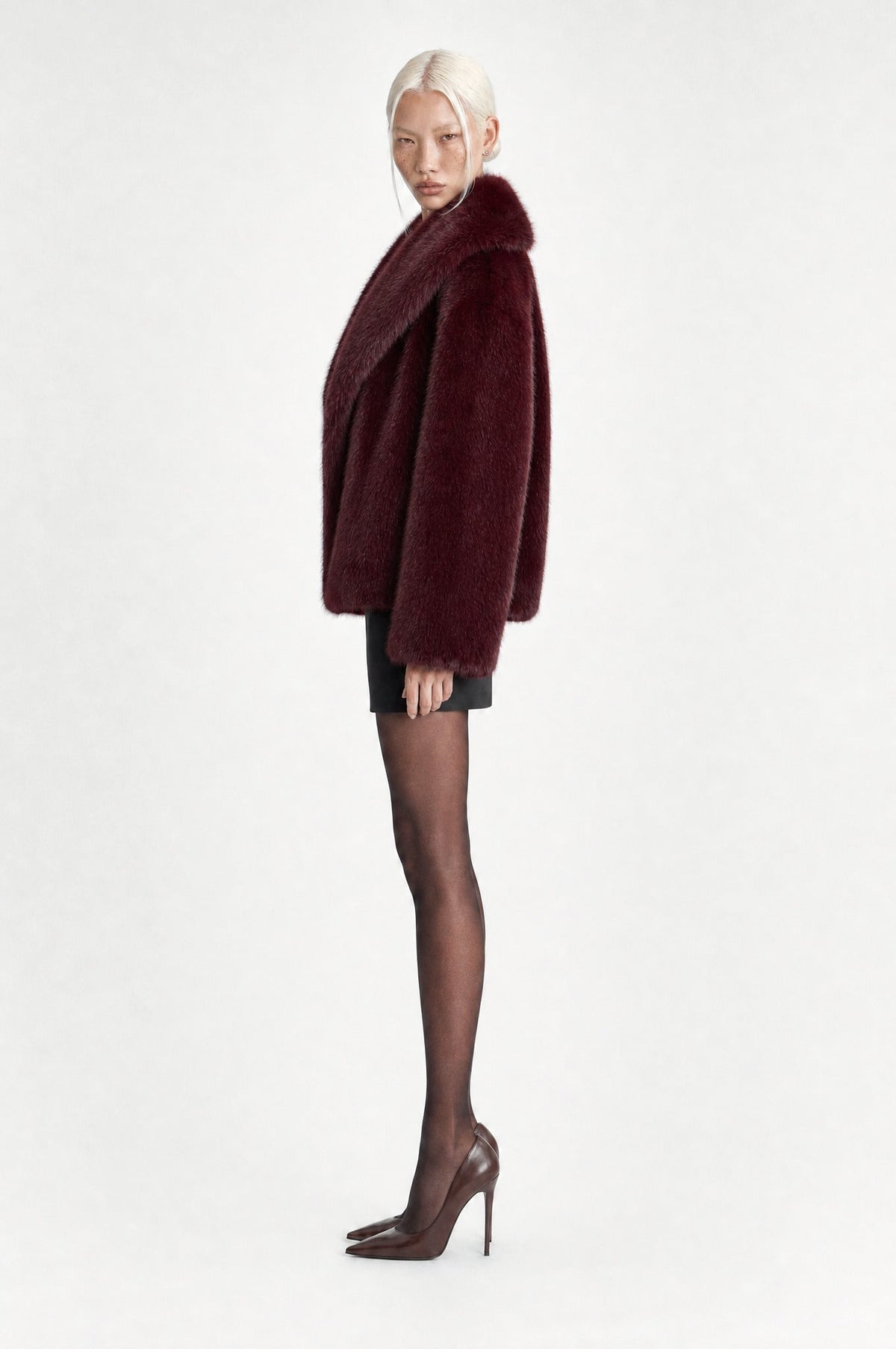 The Belgravia Faux Fur Jacket in Burgundy, side, looking at camera