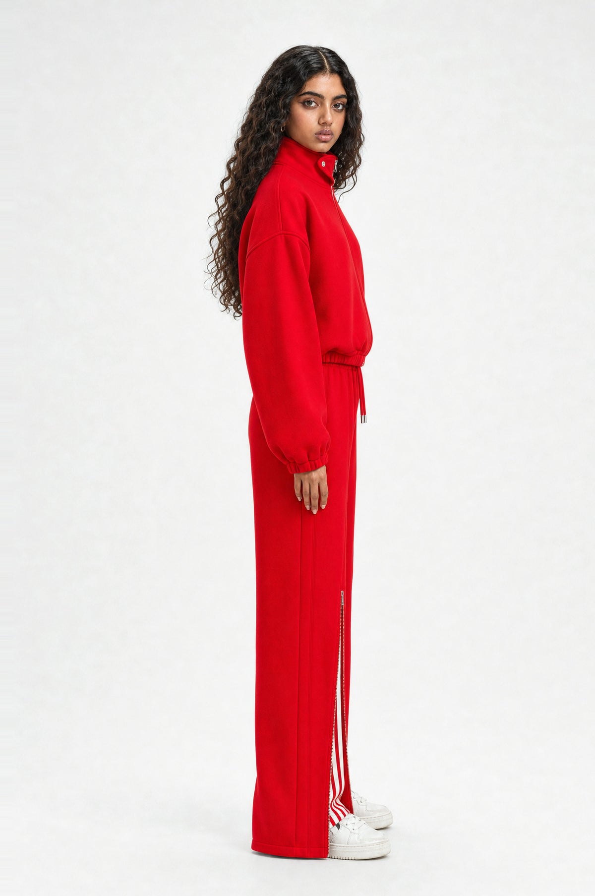 The Islington Zip Tracksuit in red, side view showing the cropped jacket and wide leg